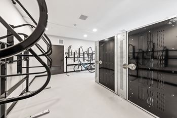 A gym with a spiral staircase and a bicycle.